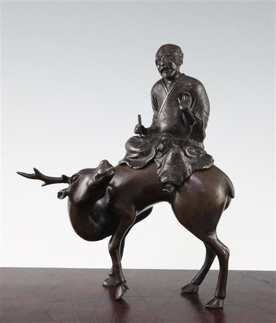 A Chinese bronze censer, modelled as a scholar riding a deer, 17th / 18th century, 25.5cm